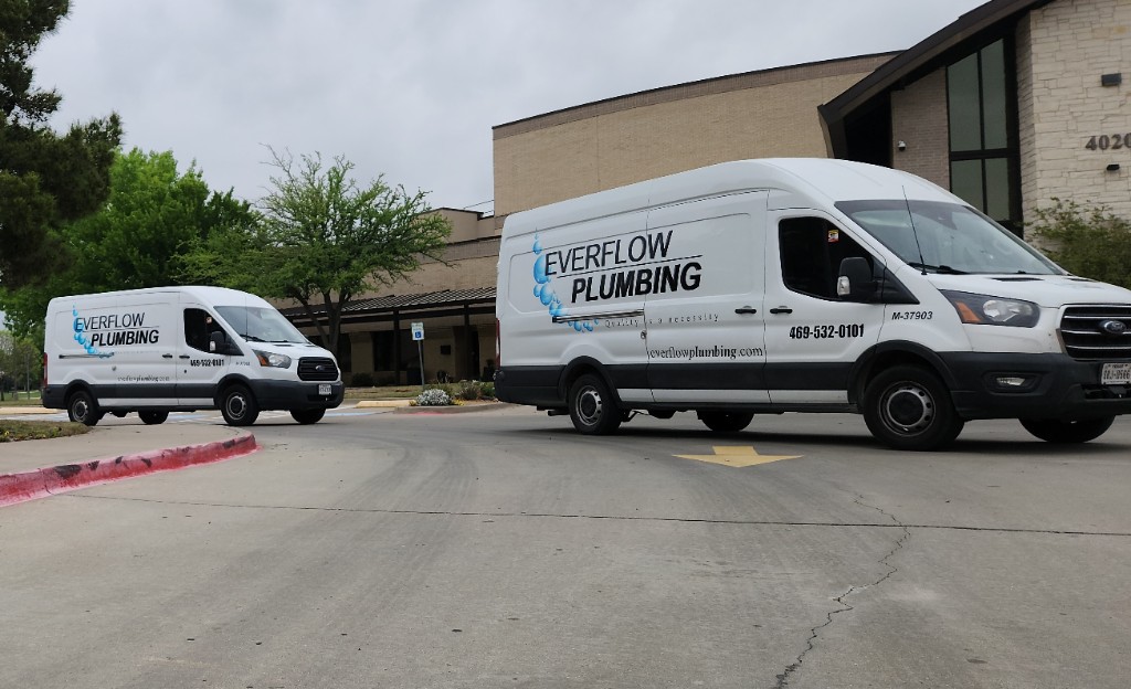 Everflow Plumbing fleet vans at the Team Everflow office — licensed TX Plumbing M-37903